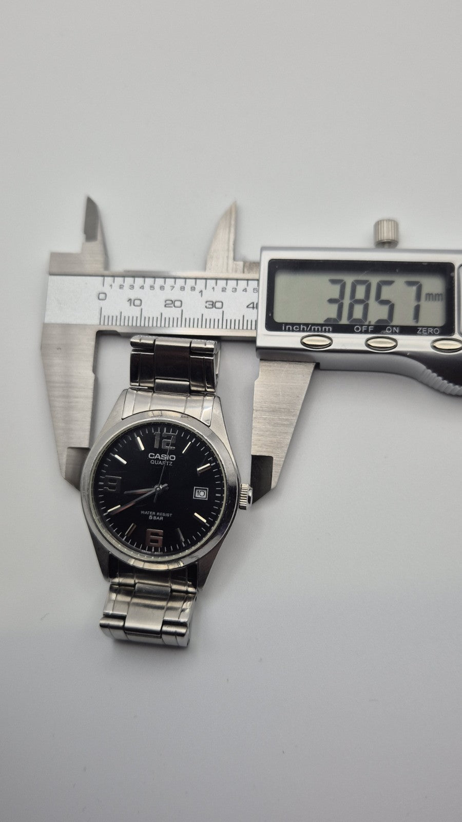 Casio MTP1181 watch with a black dial and stainless steel band12