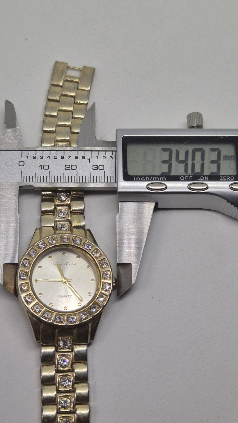 Thomas Calvi analog quartz wristwatch with a goldtoned band and a...16