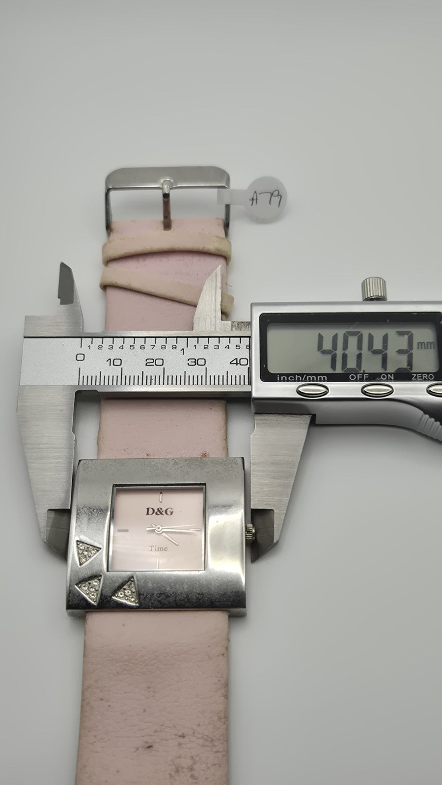 D&G Time squarefaced analog watch with a light pink leather strap and...13