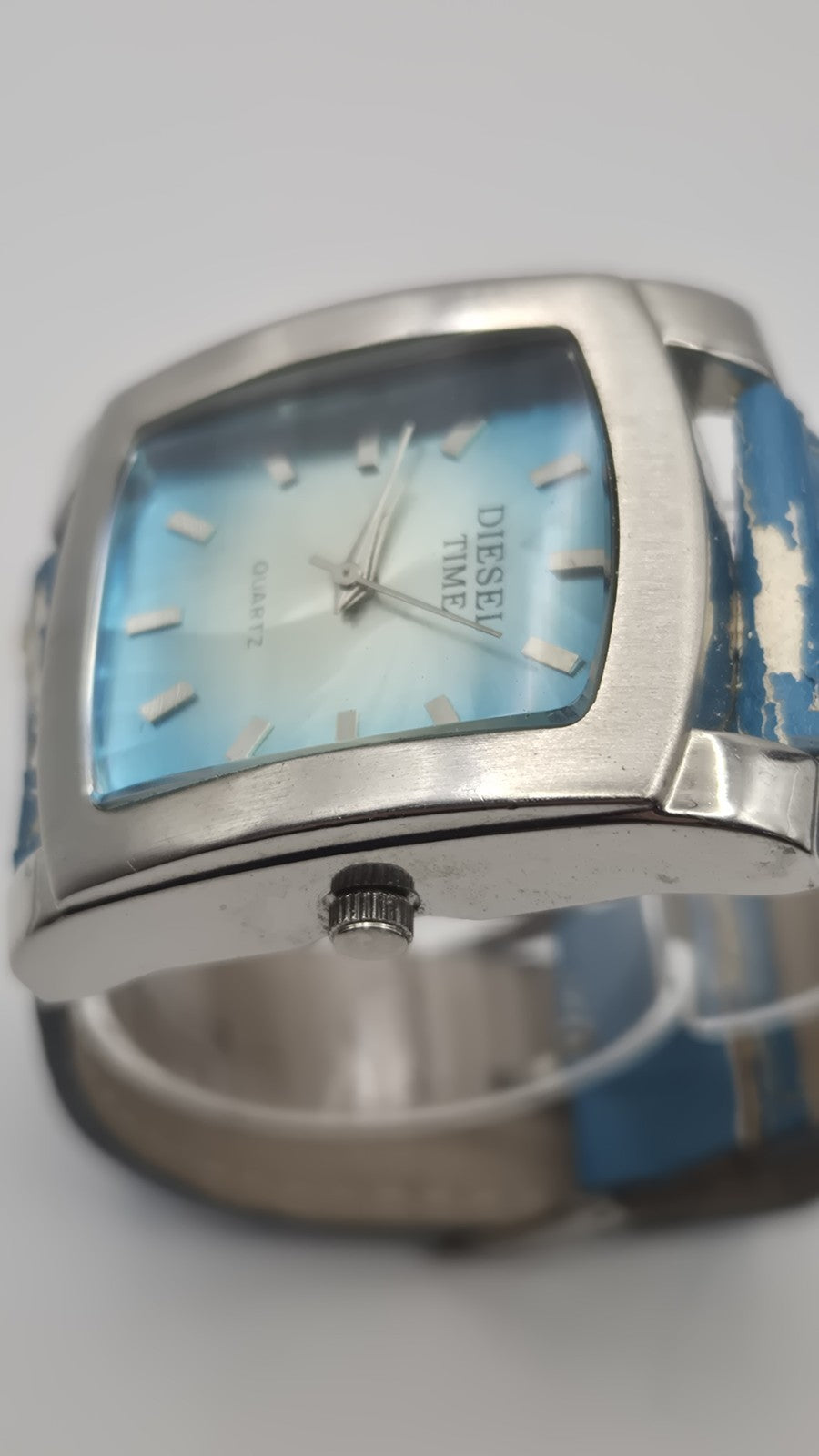 Diesel wristwatch features a rectangular stainless steel case and a blue dial...6