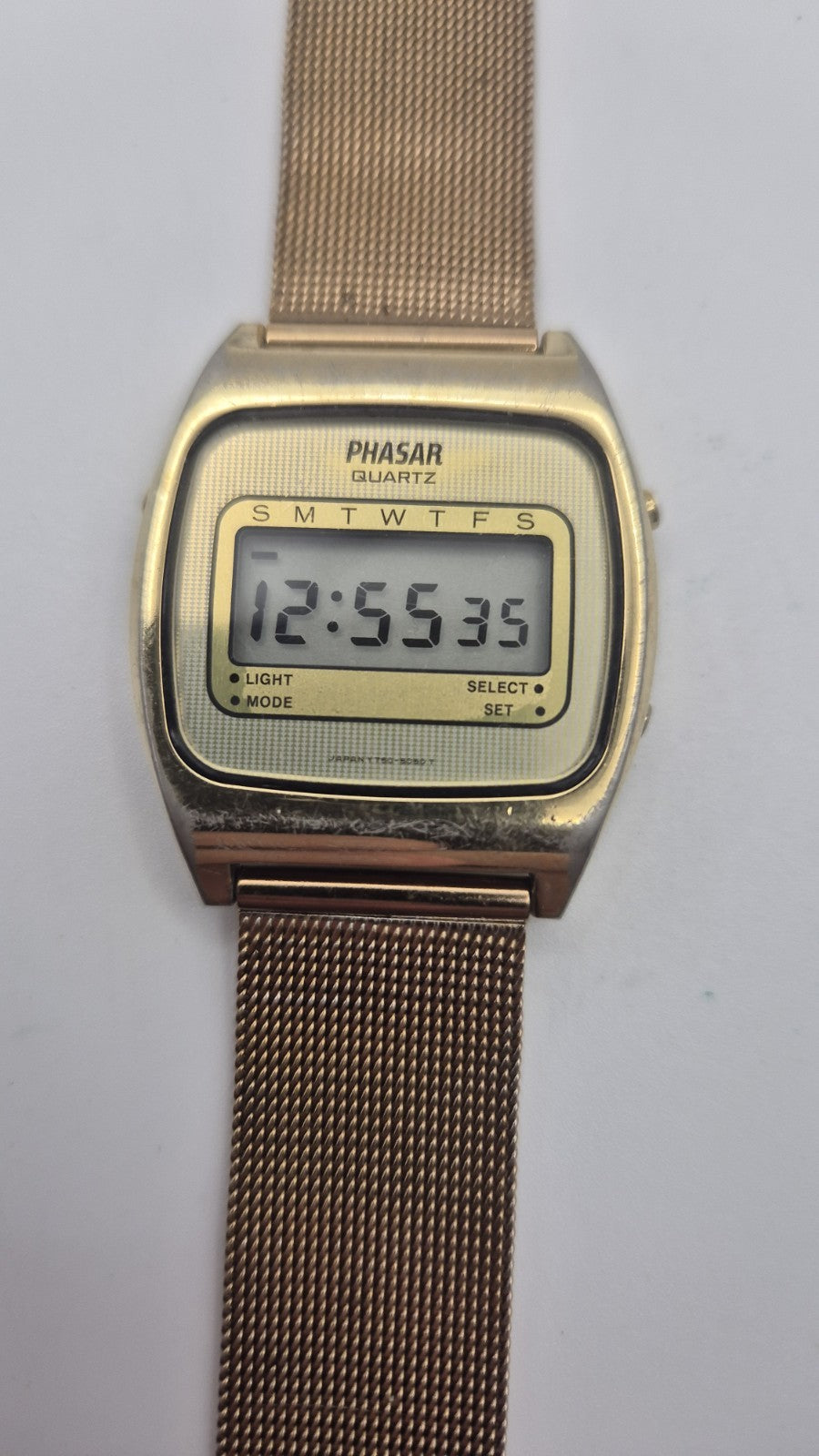 Phasar Quartz digital watch features a gold-tone metal case with wear on the...1
