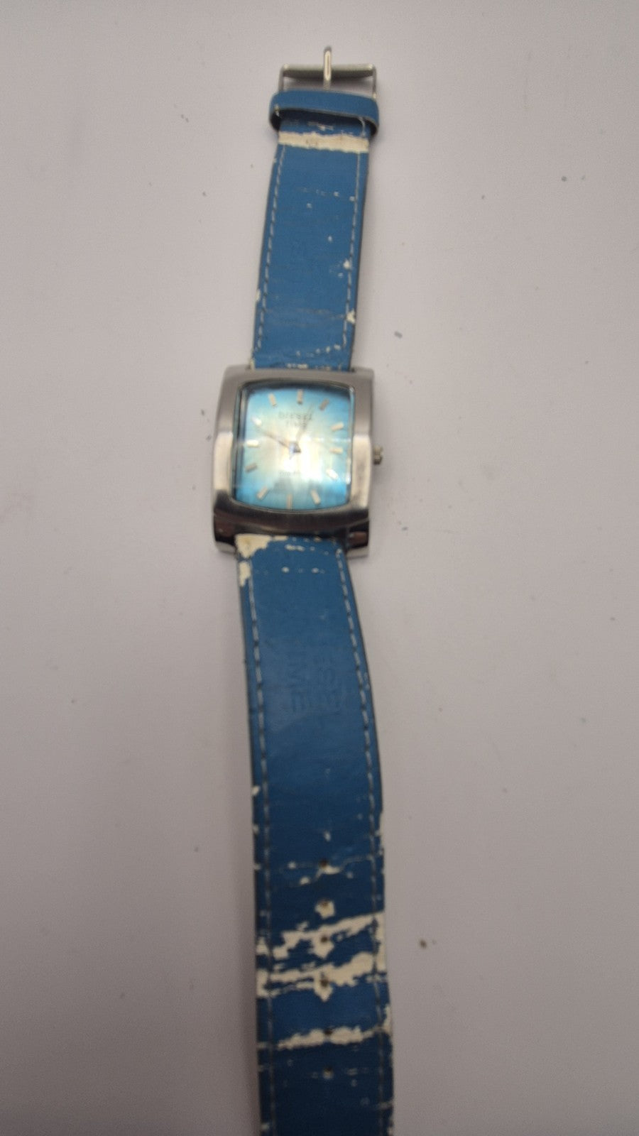 Diesel wristwatch features a rectangular stainless steel case and a blue dial...12