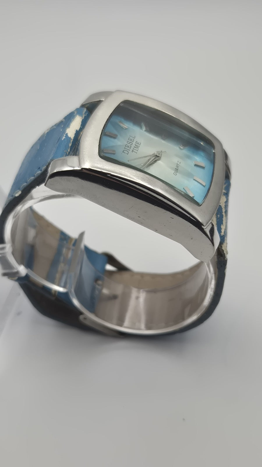 Diesel wristwatch features a rectangular stainless steel case and a blue dial...3