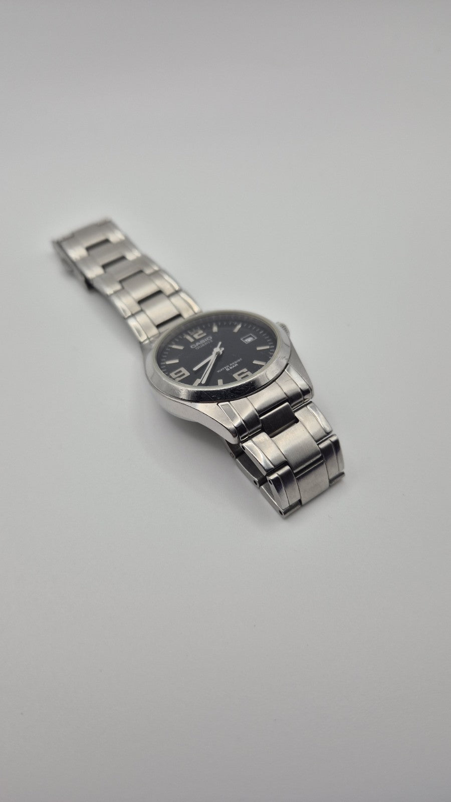Casio MTP1181 watch with a black dial and stainless steel band1