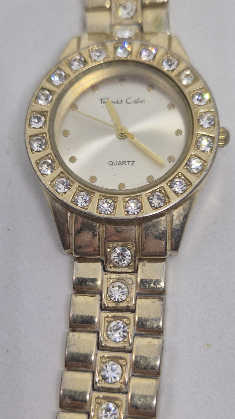 Thomas Calvi analog quartz wristwatch with a goldtoned band and a...1