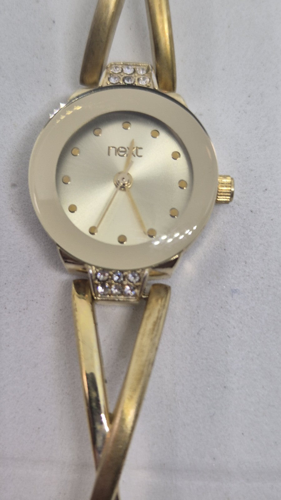 Next women's watch with a goldtone band and a crystalembellished case0