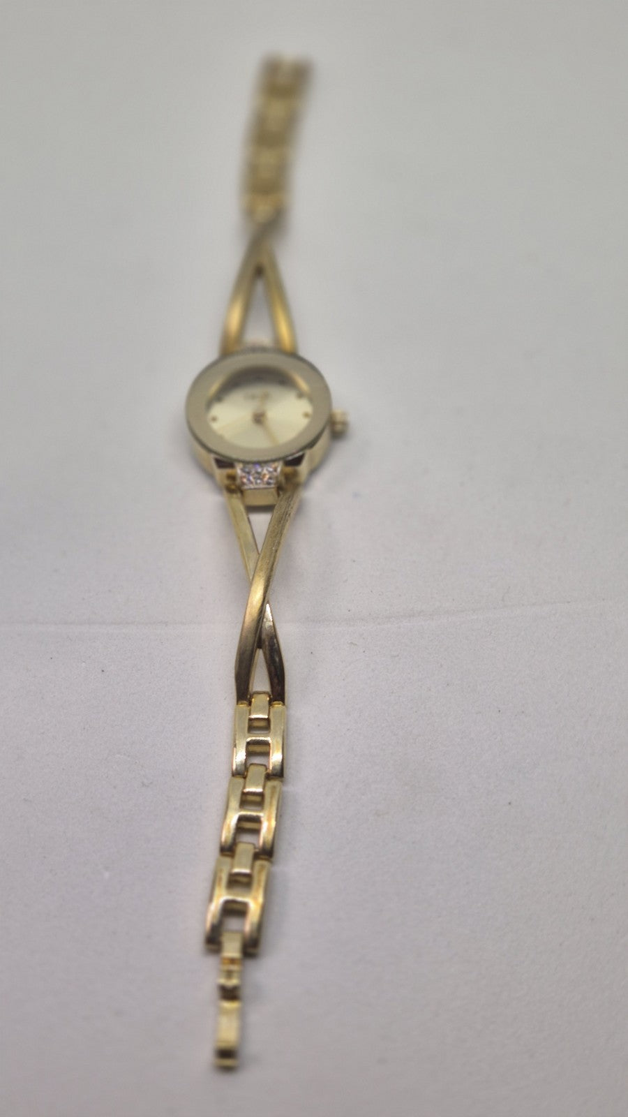Next women's watch with a goldtone band and a crystalembellished case1