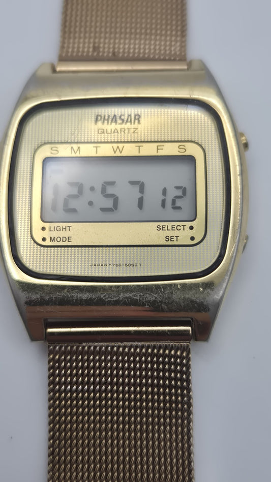 Phasar Quartz digital watch features a gold-tone metal case with wear on the...0