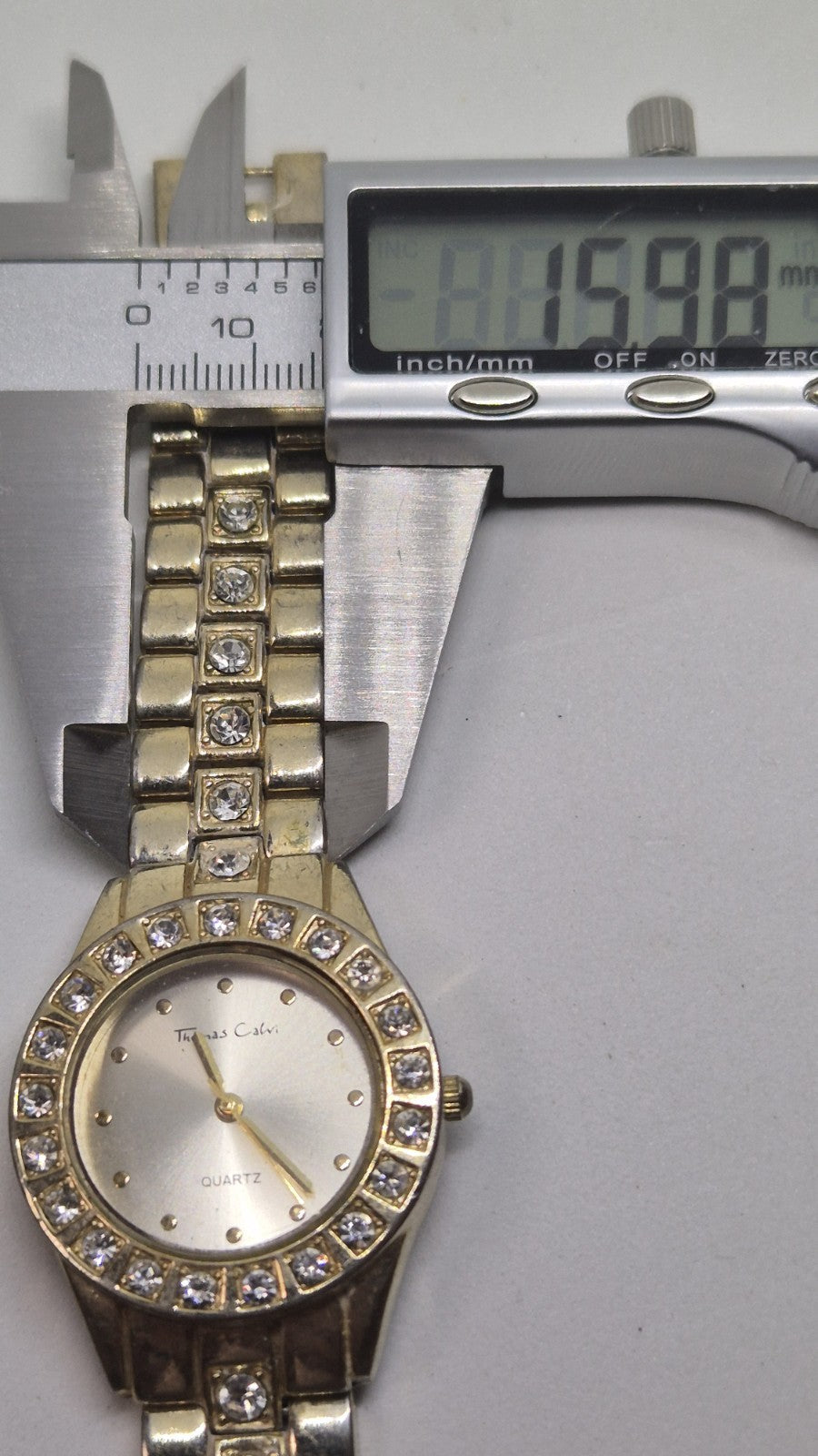 Thomas Calvi analog quartz wristwatch with a goldtoned band and a...15