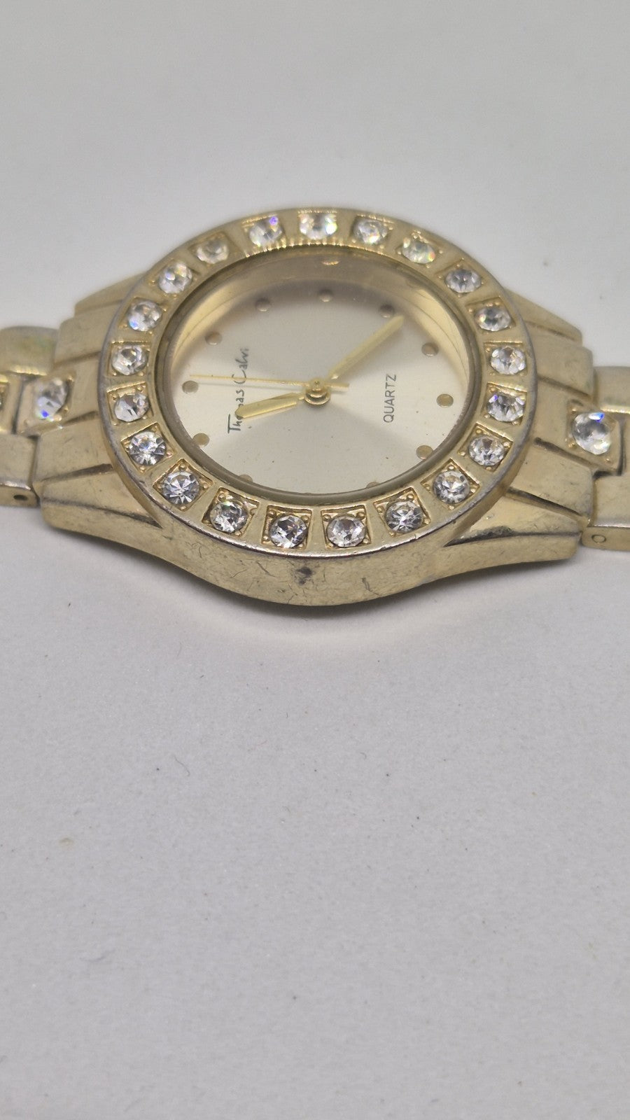 Thomas Calvi analog quartz wristwatch with a goldtoned band and a...3