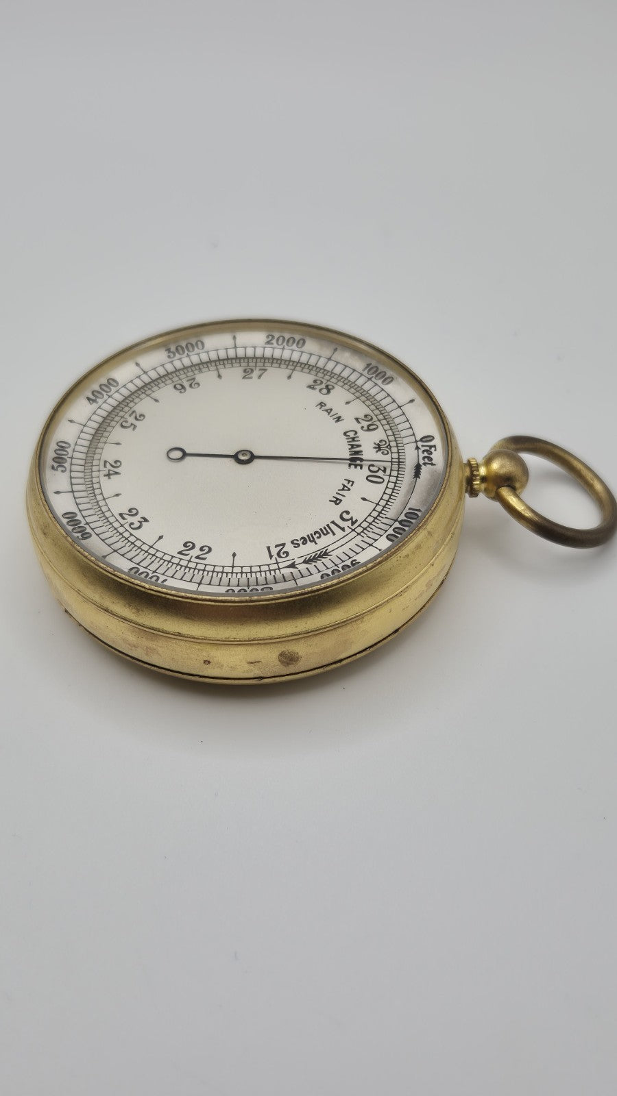 Antique pocket barometer with an altimeter scale in a brass case.20