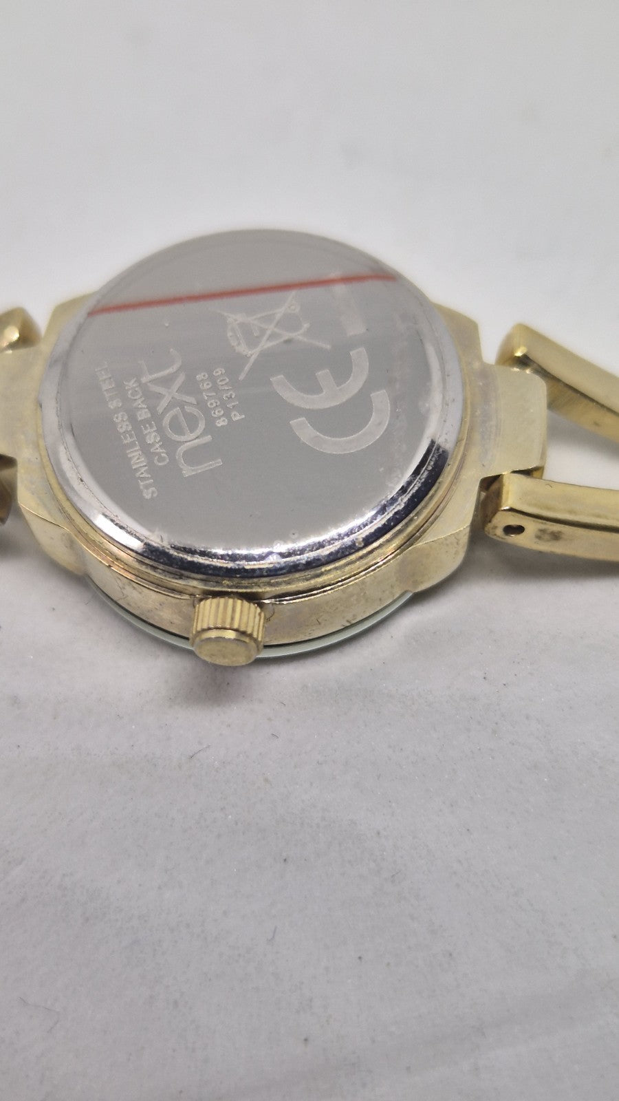 Next women's watch with a goldtone band and a crystalembellished case7