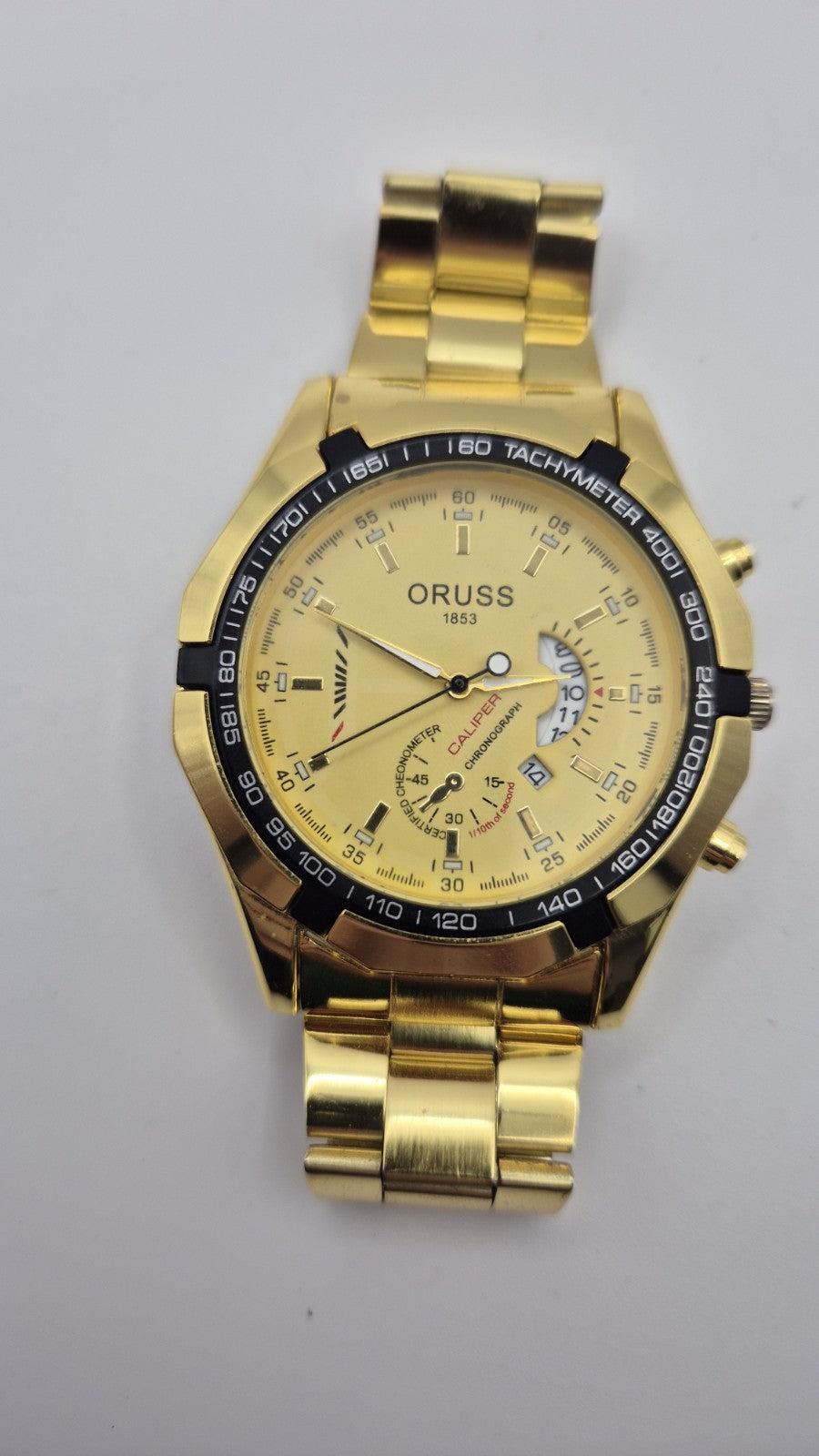 Oruss 1853 men's gold-tone quartz chronograph watch featuring a black tachymetre9