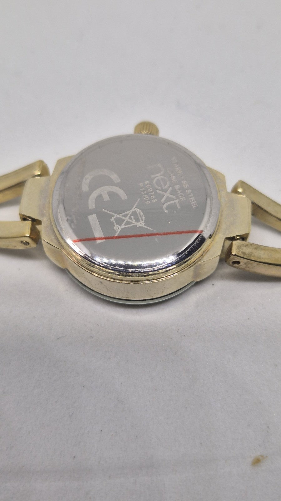 Next women's watch with a goldtone band and a crystalembellished case8