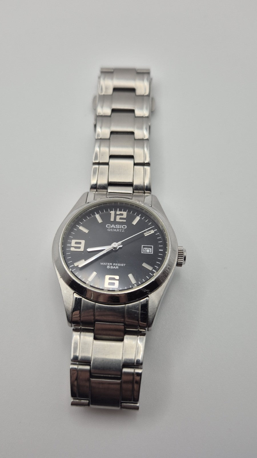 Casio MTP1181 watch with a black dial and stainless steel band5