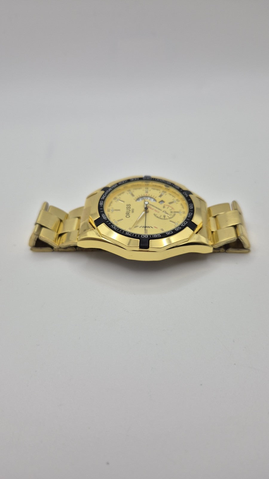 Oruss 1853 men's gold-tone quartz chronograph watch featuring a black tachymetre10