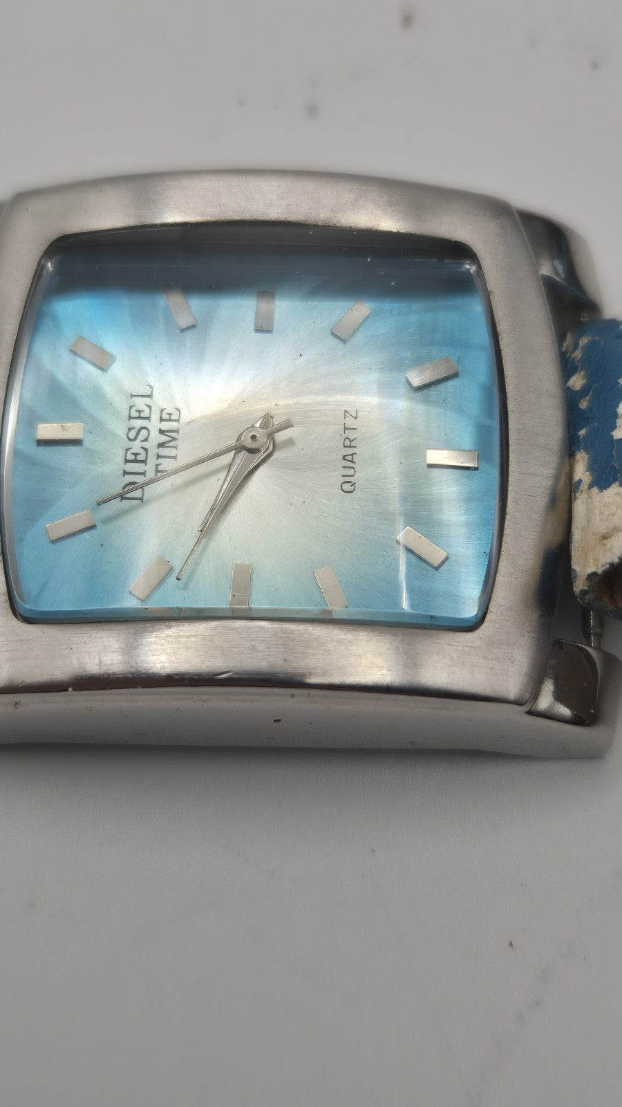 Diesel wristwatch features a rectangular stainless steel case and a blue dial...11
