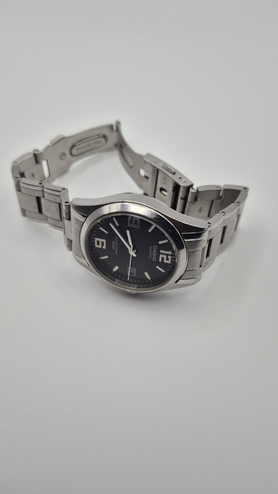Casio MTP1181 watch with a black dial and stainless steel band6