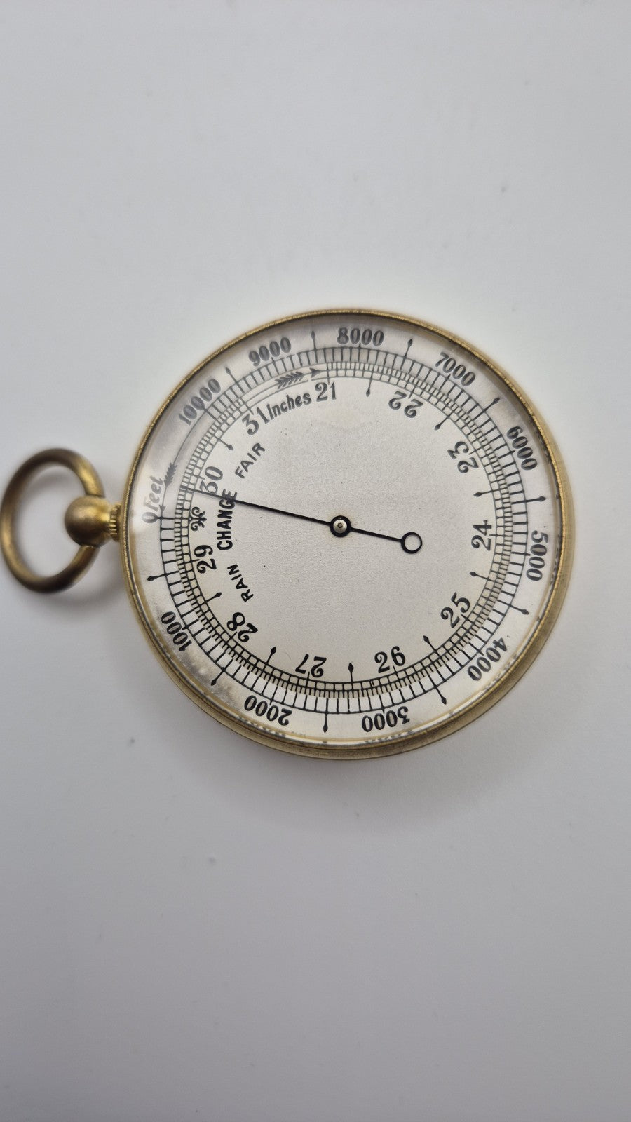Antique pocket barometer with an altimeter scale in a brass case.1