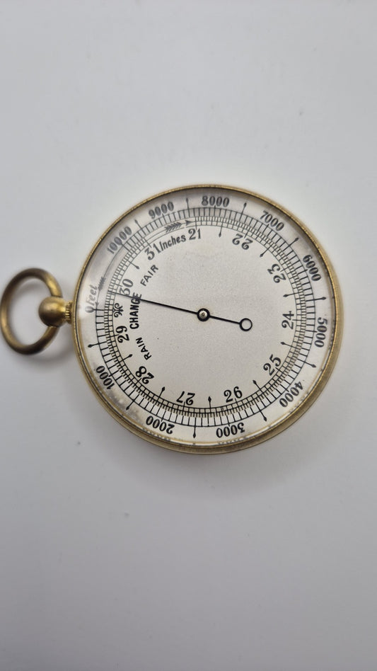 Antique pocket barometer with an altimeter scale in a brass case.1