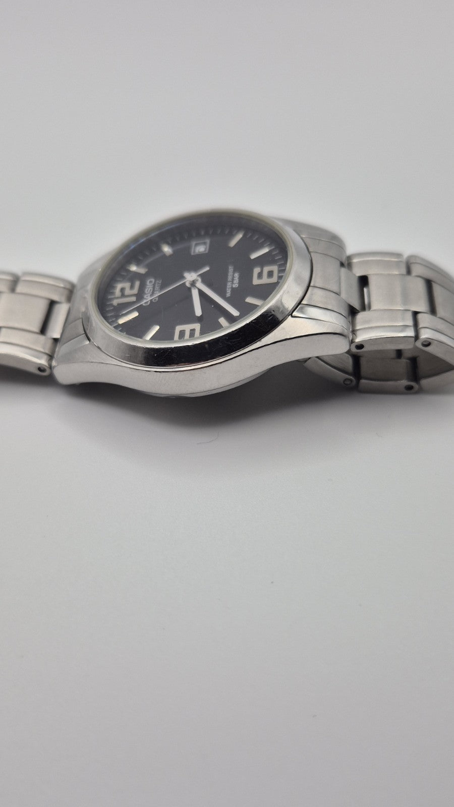 Casio MTP1181 watch with a black dial and stainless steel band4