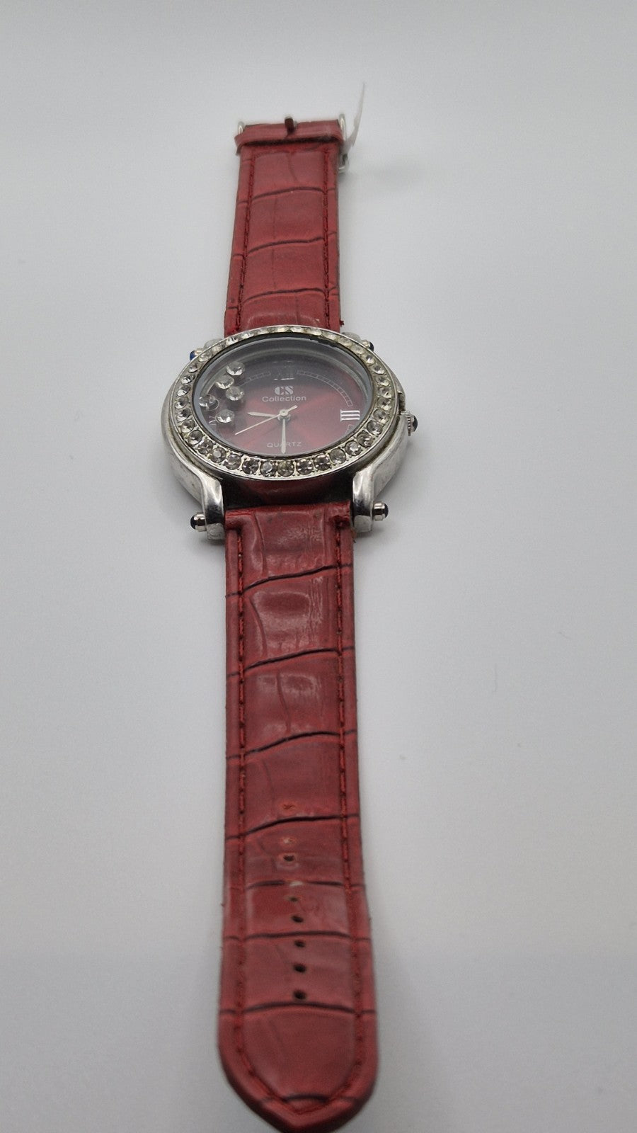 CS Collection Quartz watch with a red band and a crystalstudded bezel.3