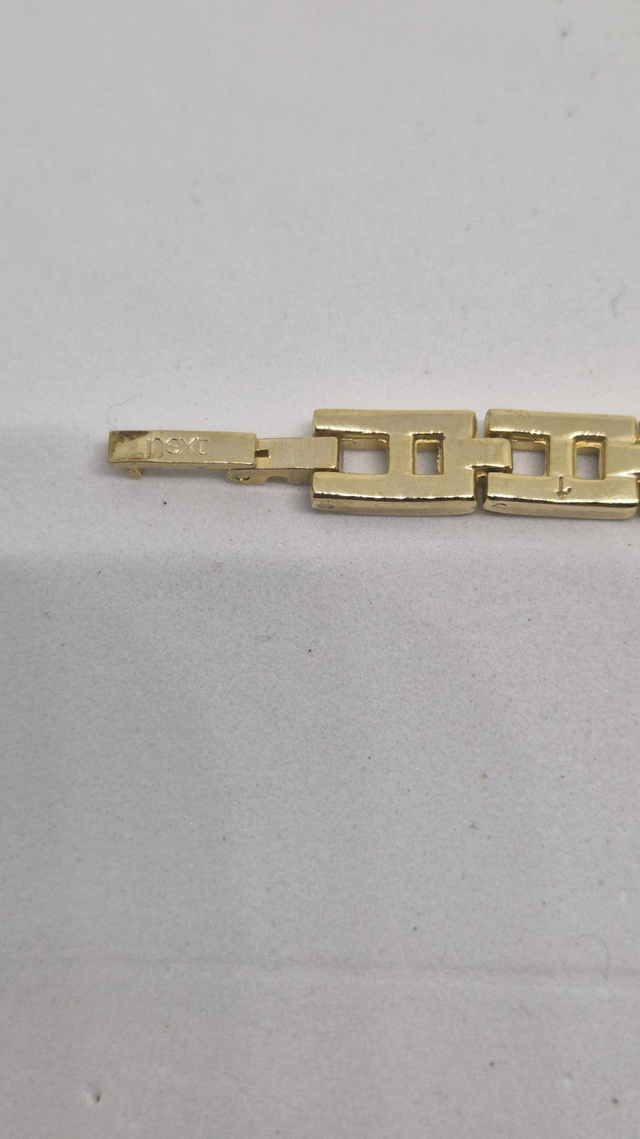 Next women's watch with a goldtone band and a crystalembellished case9