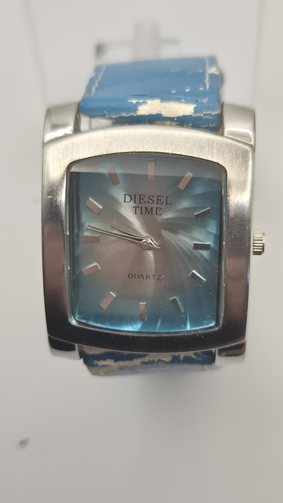 Diesel wristwatch features a rectangular stainless steel case and a blue dial...2