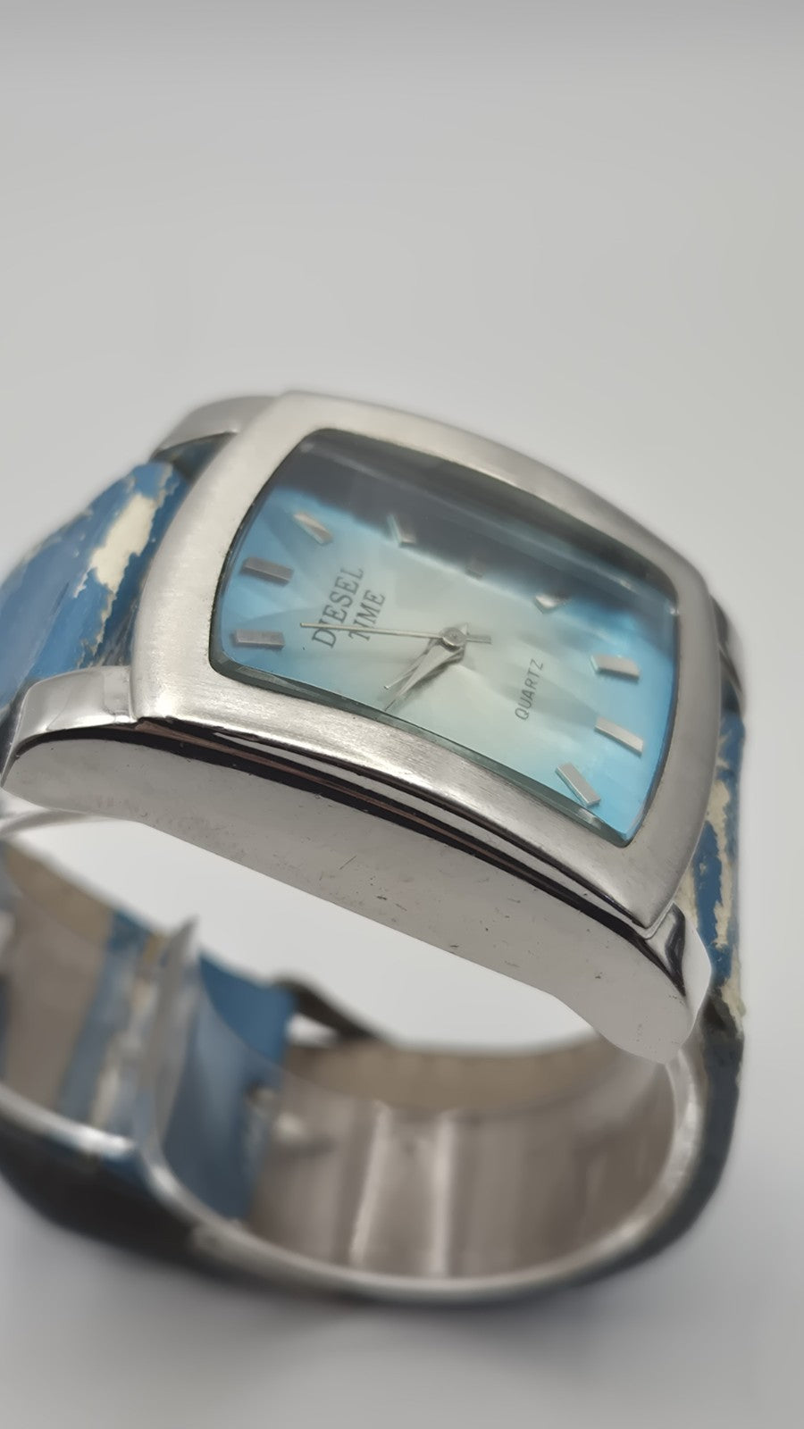 Diesel wristwatch features a rectangular stainless steel case and a blue dial...4