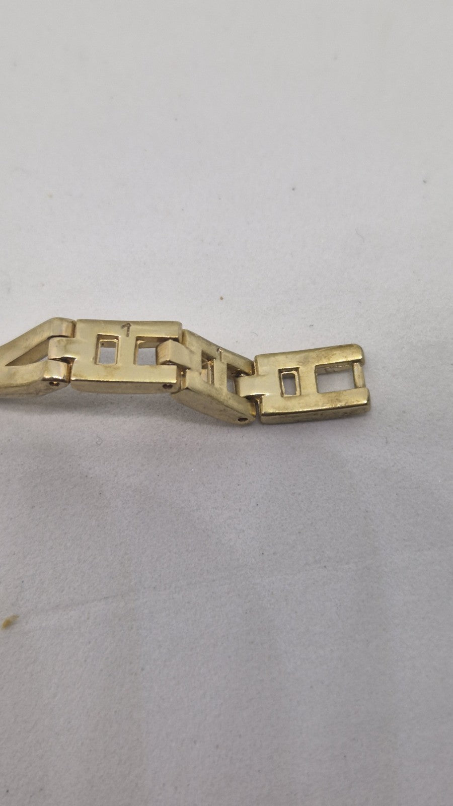 Next women's watch with a goldtone band and a crystalembellished case10