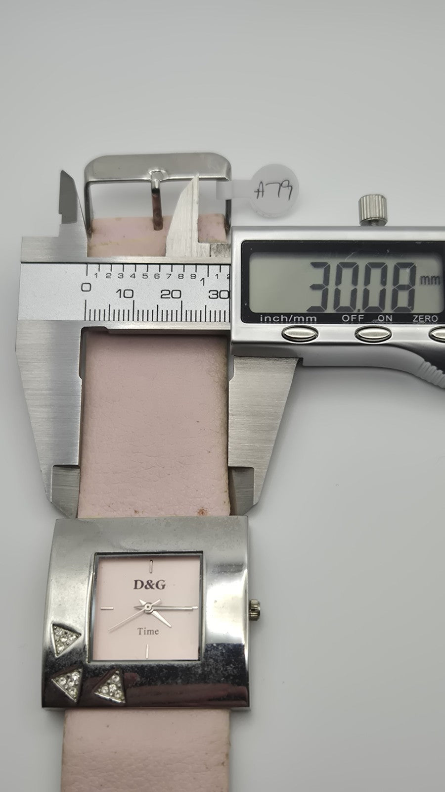 D&G Time squarefaced analog watch with a light pink leather strap and...12