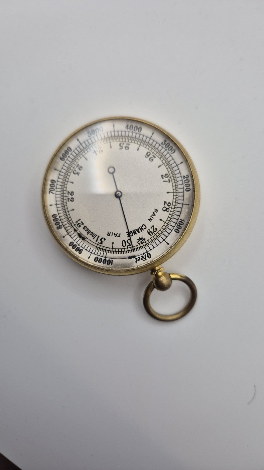 Antique pocket barometer with an altimeter scale in a brass case.4