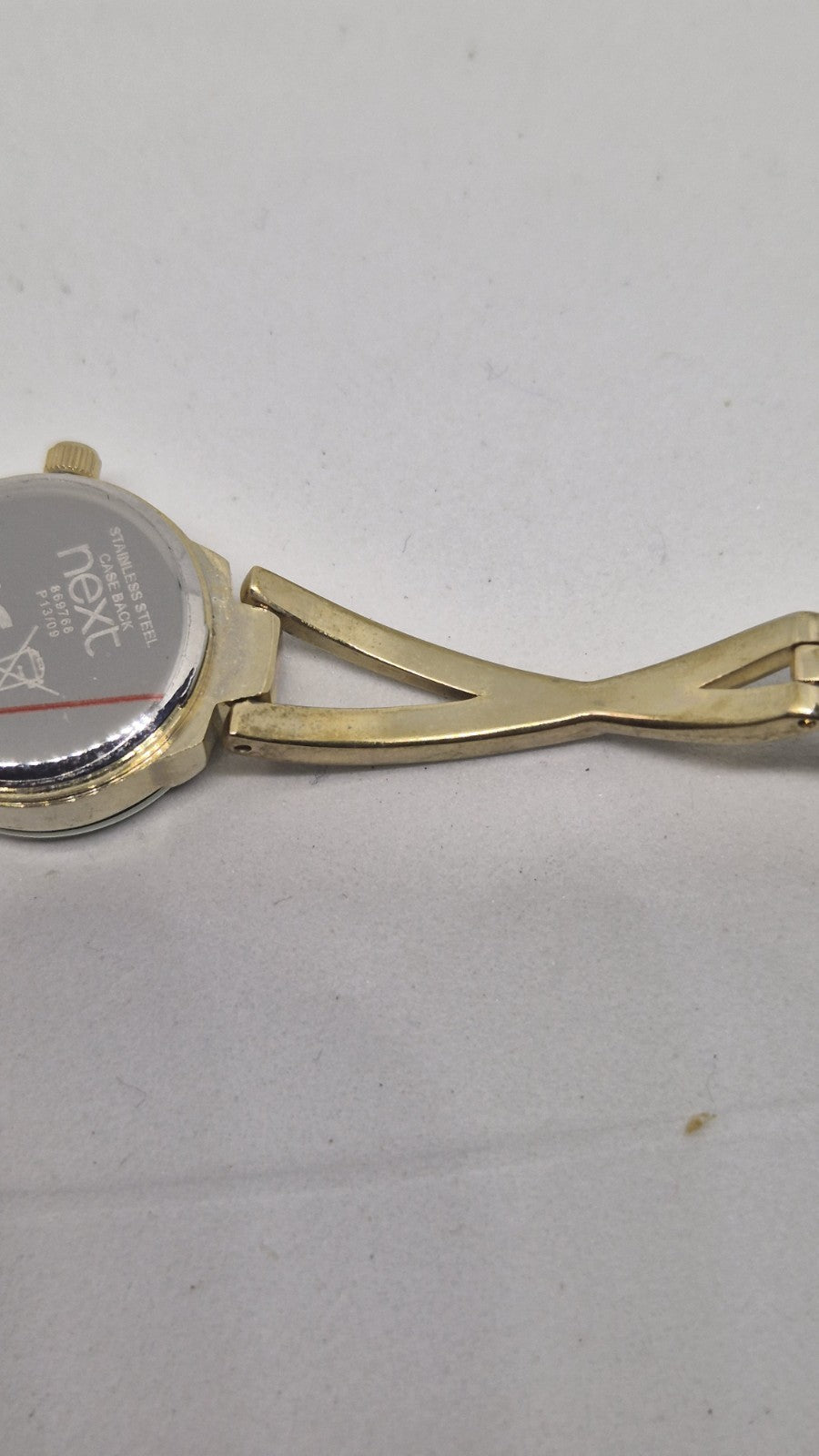 Next women's watch with a goldtone band and a crystalembellished case11