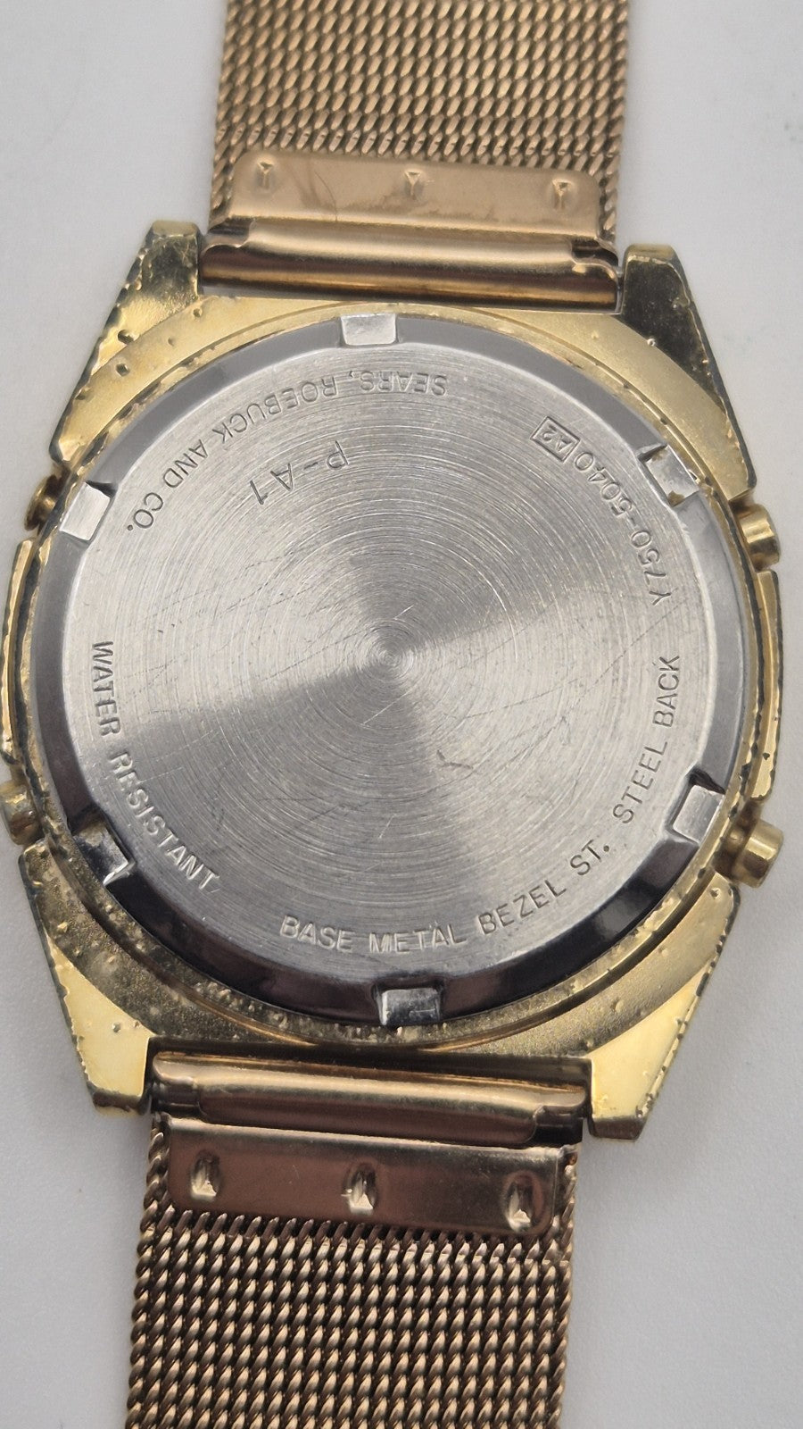 Phasar Quartz digital watch features a gold-tone metal case with wear on the...9