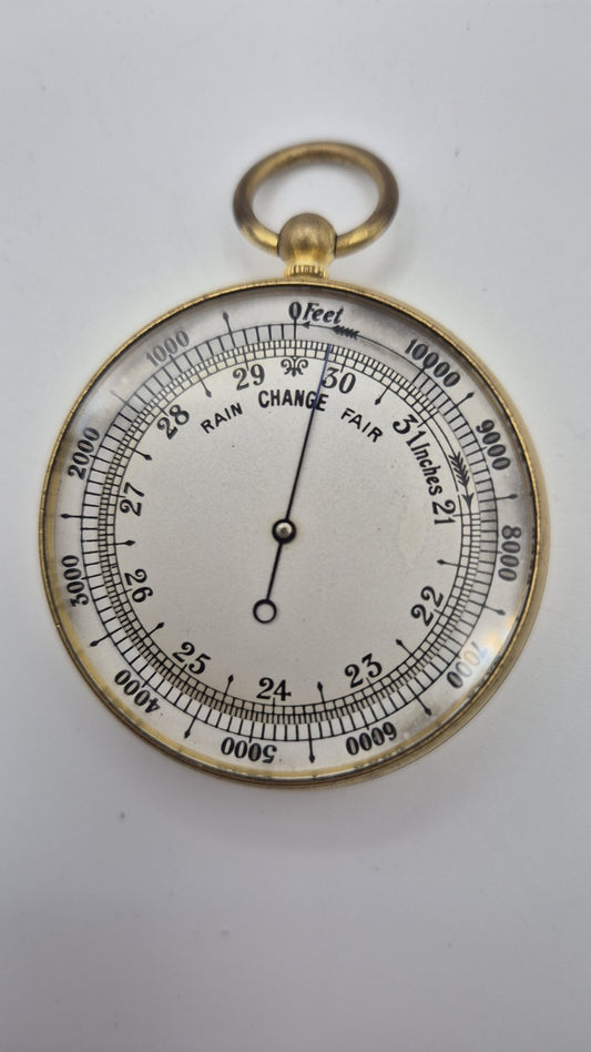Antique pocket barometer with an altimeter scale in a brass case.0