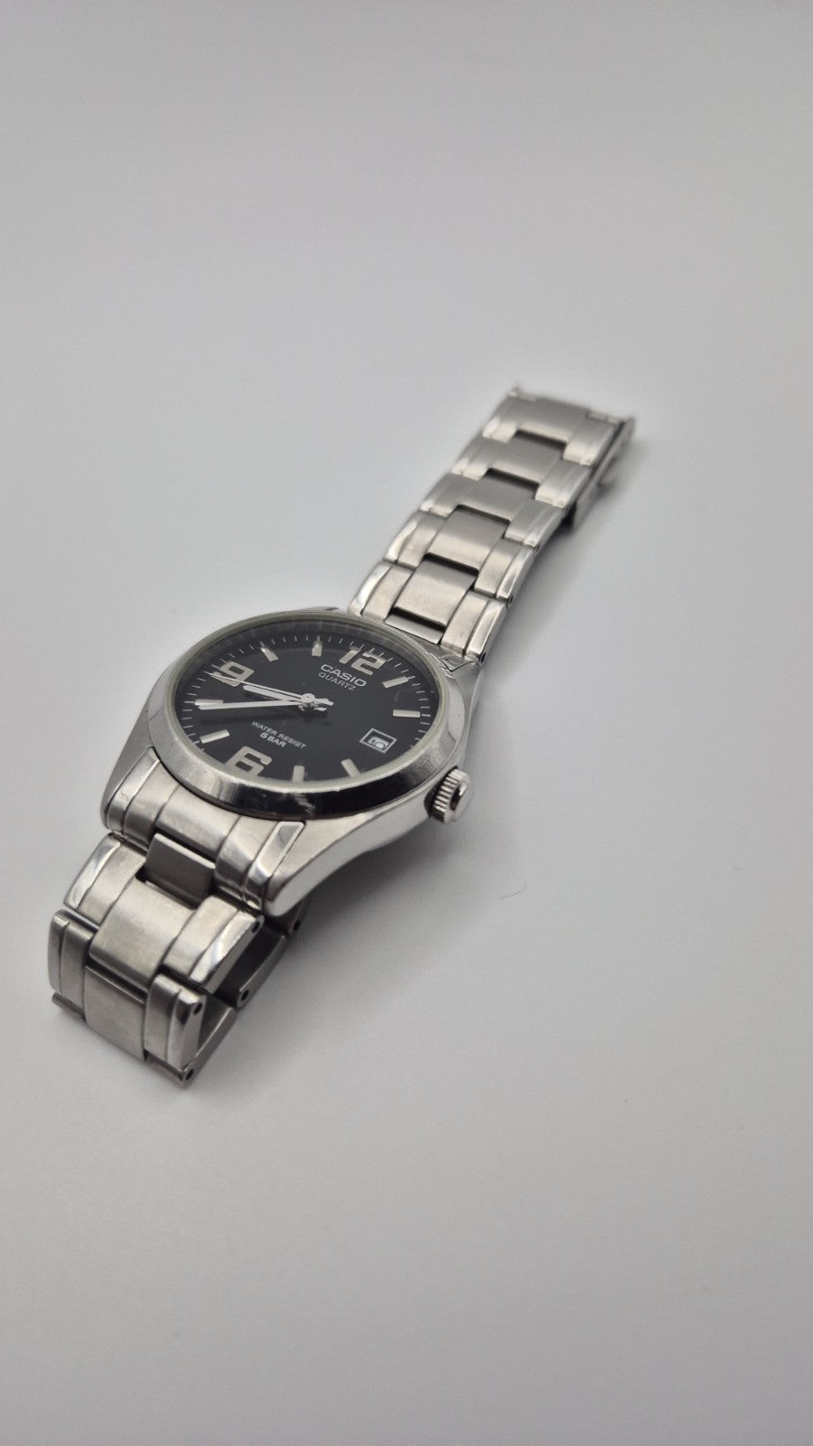 Casio MTP1181 watch with a black dial and stainless steel band2