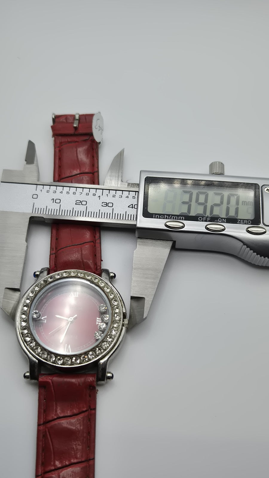 CS Collection Quartz watch with a red band and a crystalstudded bezel.12