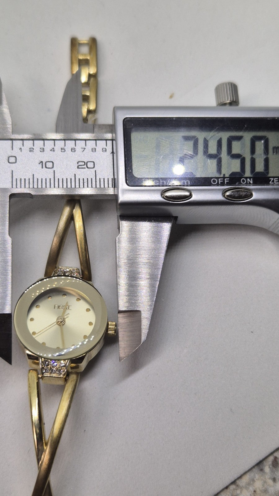 Next women's watch with a goldtone band and a crystalembellished case16