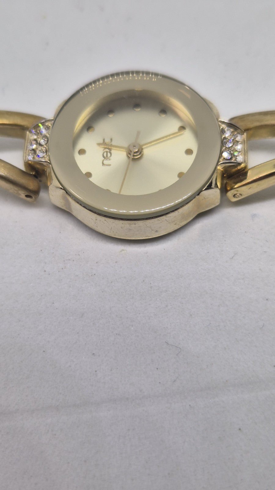 Next women's watch with a goldtone band and a crystalembellished case3
