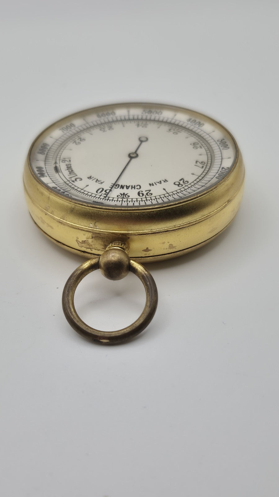 Antique pocket barometer with an altimeter scale in a brass case.6