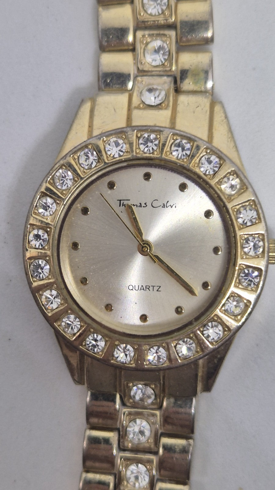 Thomas Calvi analog quartz wristwatch with a goldtoned band and a...2
