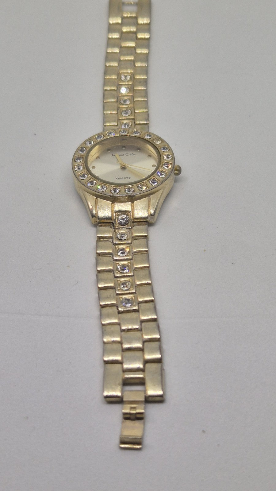 Thomas Calvi analog quartz wristwatch with a goldtoned band and a...5