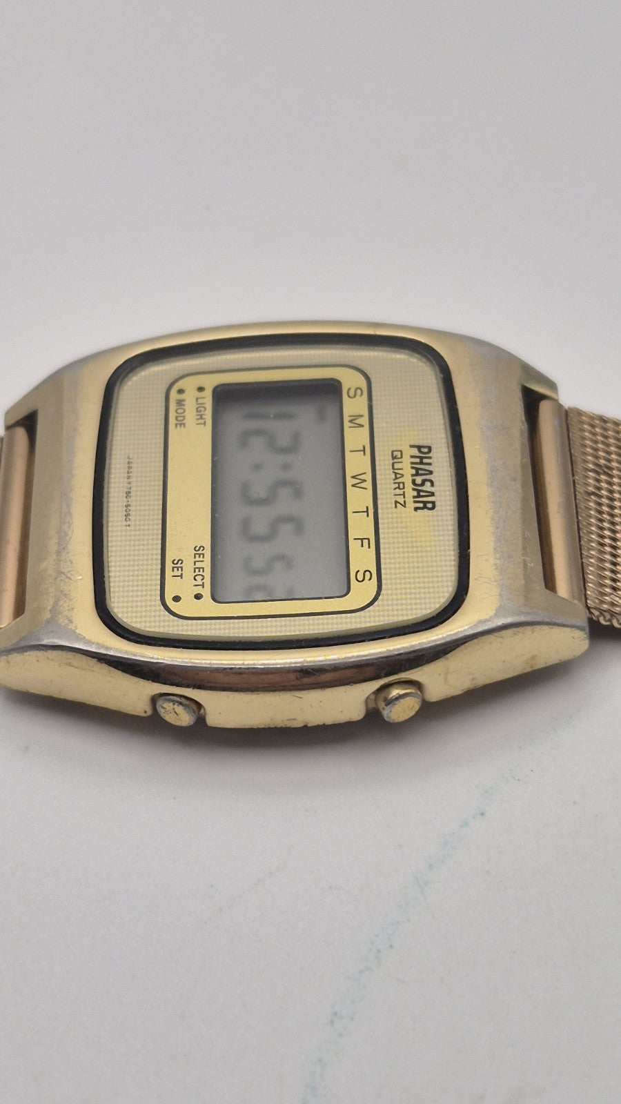 Phasar Quartz digital watch features a gold-tone metal case with wear on the...2