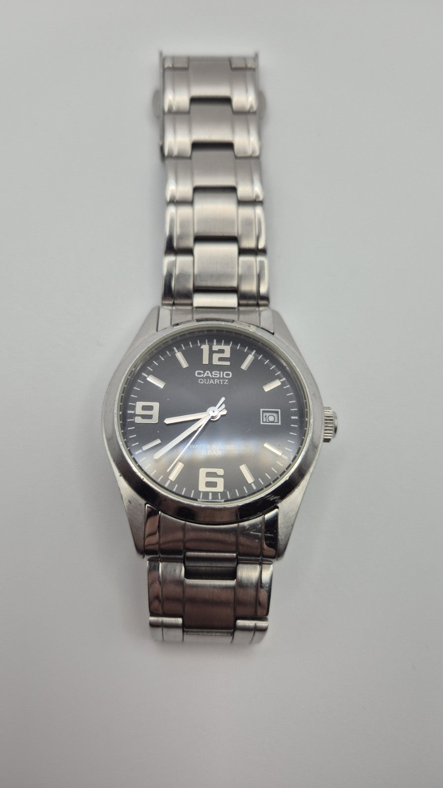Casio MTP1181 watch with a black dial and stainless steel band0