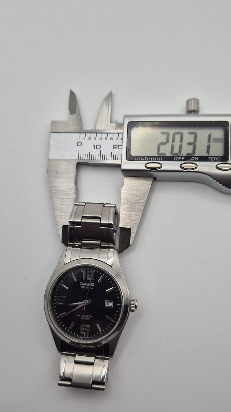 Casio MTP1181 watch with a black dial and stainless steel band11