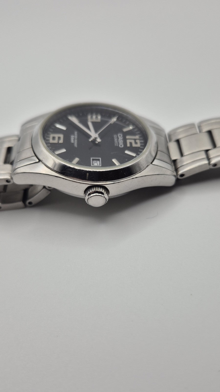 Casio MTP1181 watch with a black dial and stainless steel band3