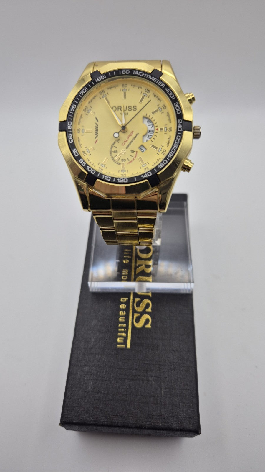 Oruss 1853 men's gold-tone quartz chronograph watch featuring a black tachymetre0