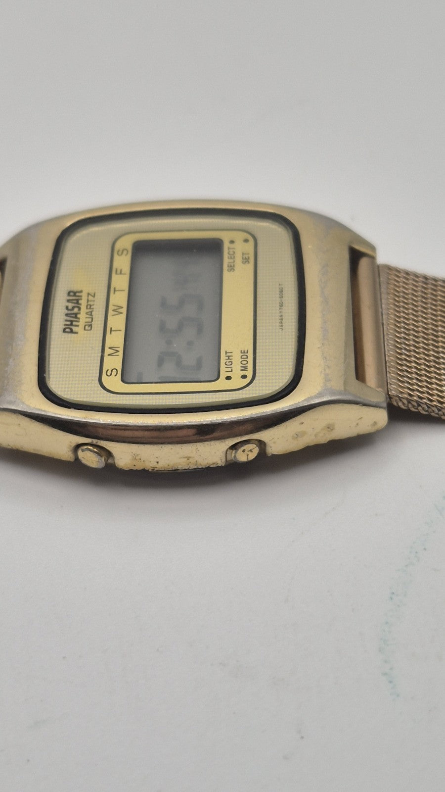 Phasar Quartz digital watch features a gold-tone metal case with wear on the...3