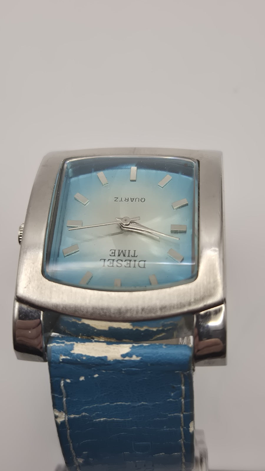 Diesel wristwatch features a rectangular stainless steel case and a blue dial...8