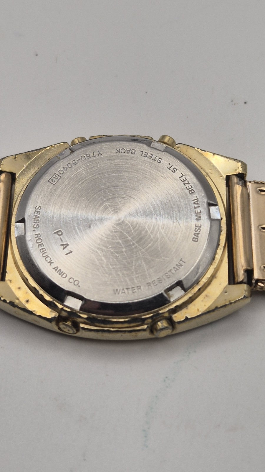 Phasar Quartz digital watch features a gold-tone metal case with wear on the...7